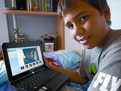 Eduard Secanell, de 12 anys, amb l'ordinador que utilitza a classe.