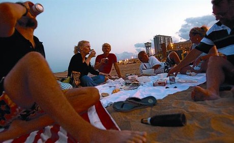Un grup de joves sopen i consumeixen alcohol a la Barceloneta, la setmana passada.